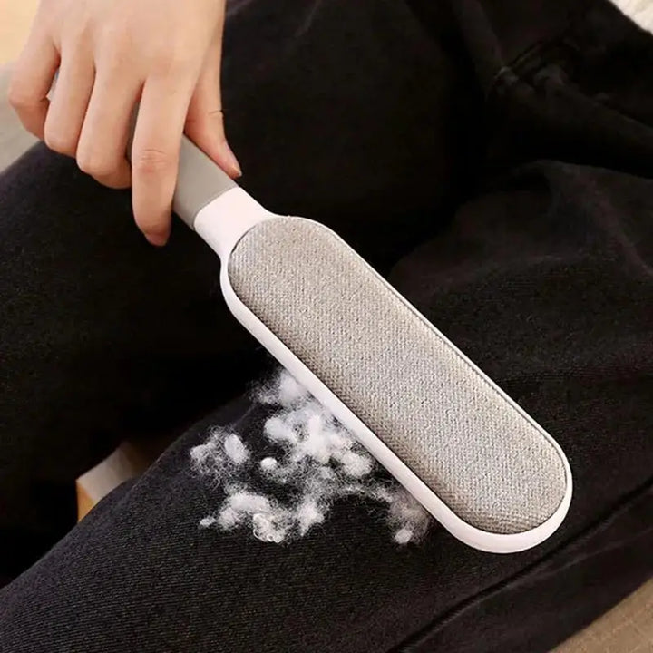 Person using a pet hair remover on dark fabric
