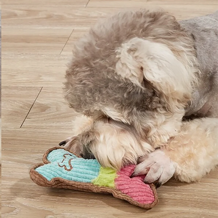 Dog Chew Toy shaped like a colorful bone, shown with a dog playing