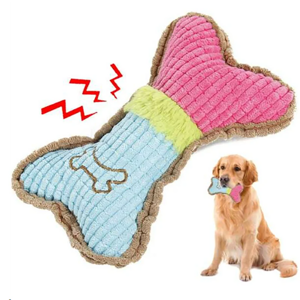 Colorful plush Dog Chew Toy shaped like a bone next to a small dog