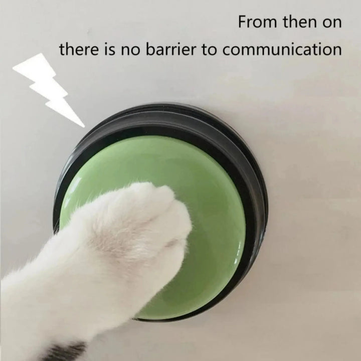 Cat paw pressing a green Dog Communication Button